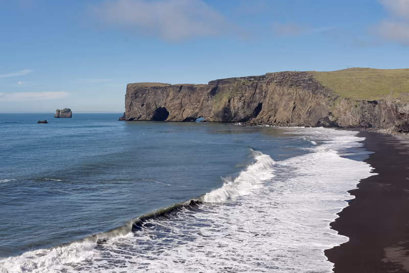 Black sand and white surf below the cliffs of Dyrhólaey
