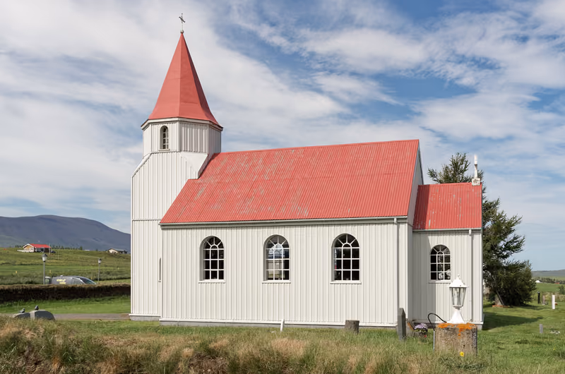 A white church with a red roof at Glaumbær